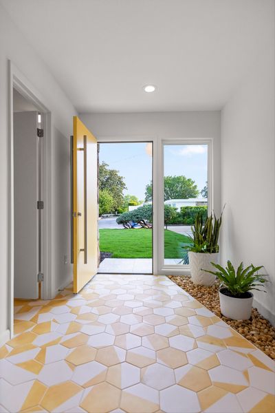 Hexagonal yellow and white tiles clad the entryway.
